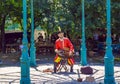 Street musician playing wheel fiddle or hurdy-gurdy - stringed instrument in Budapest